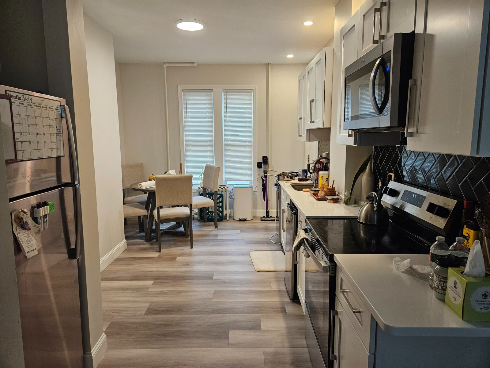 Open-concept kitchen with stainless-steel appliances and quartz countertops at 26 Lancaster St #1R
