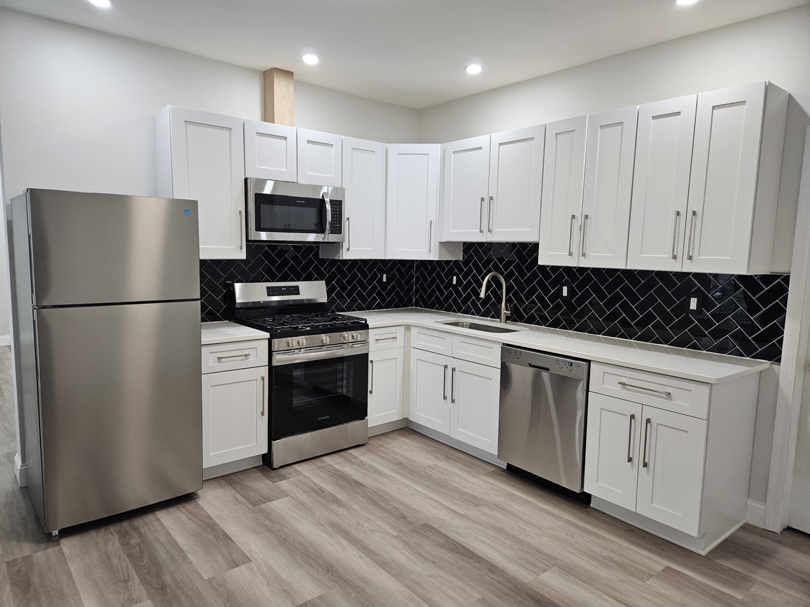 New white shaker kitchen with stainless-steel appliances at 28 Lancaster St #1R